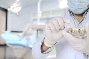 a dentist holding his implant model
