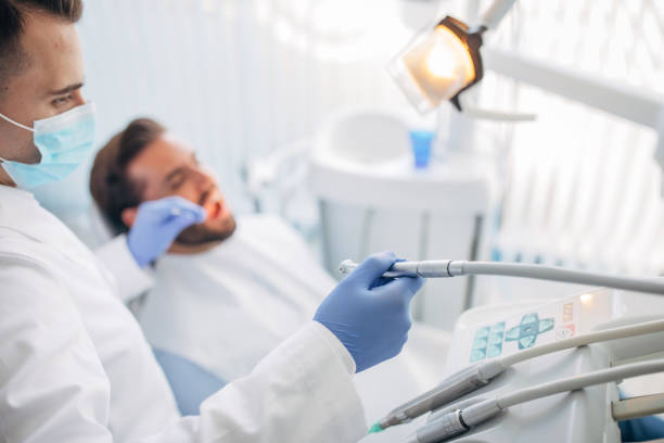 a dentist and a man during a dental appointment